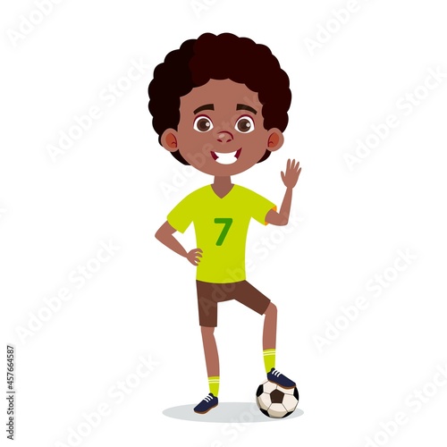 Black teen soccer player. Smiling boy standing with one foot on a soccer ball