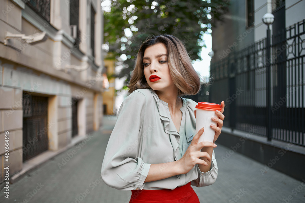 Fototapeta premium blonde outdoors red skirt hot drink outdoors in summer
