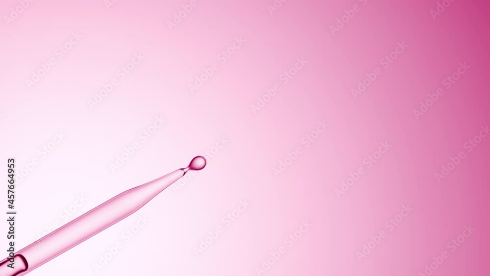 Macro shot of clear drops are dripping down from lab dropper on pale pink background | Abstract body care lotion ingredients formulating concept Macro shot of clear drops are dripping down from lab dropper on pale pink background | Abstract body care lotion ingredients formulating concept