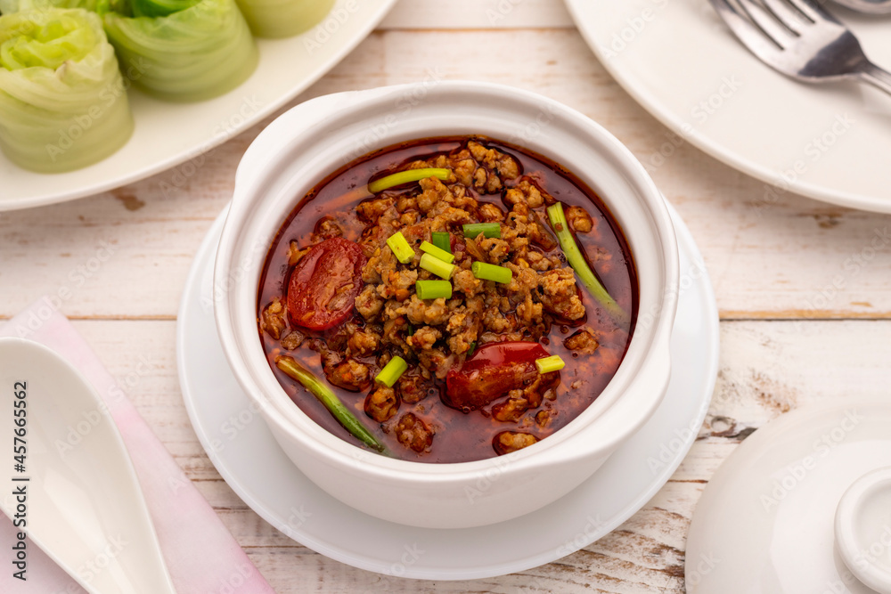 Spicy minced pork dip with red cherry tomatoes or nam prik moo, a spicy relish that is good to eat with fresh, blanched or parboiled vegetable. It is a kind of Isan (northeastern) Thai food style. Spicy minced pork dip with red cherry tomatoes or nam prik moo, a spicy relish that is good to eat with fresh, blanched or parboiled vegetable. It is a kind of Isan (northeastern) Thai food style.