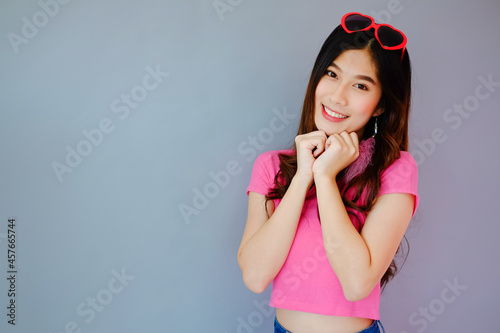 Portrait beautiful asian cheerful girl and beaming smile with fashion eyewear on gray background, emotions action, happy summer life concept