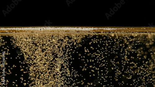 Close-up of champagne bubbles background with foam. photo
