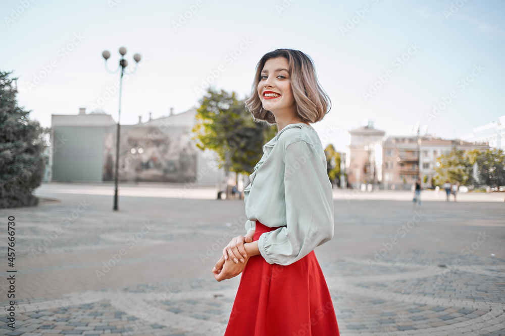 Fototapeta premium pretty woman in a red skirt city walk fun leisure lifestyle