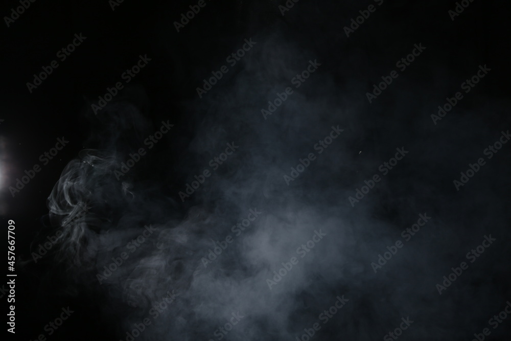 Obraz premium Artificial magic smoke isolated on dark background