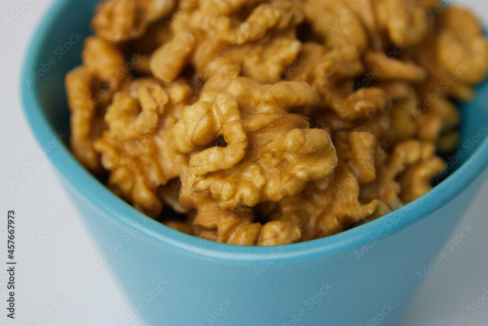Walnuts in Blue Bowl White Background Close Up Walnuts in Blue Bowl White Background Close Up