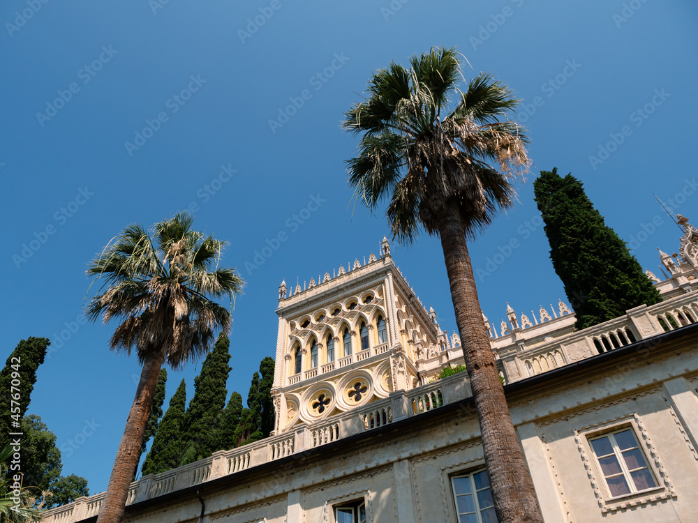Villa Borghese on Isola del Garda Island, a Palace in Venetian Neo-Gothic Style Facade with Palm Trees