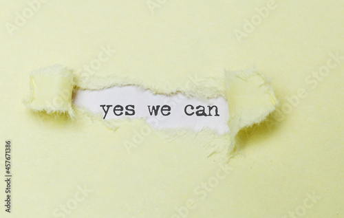 Yes we can. Positive thinking concept. Inspirational words on yellow paper torn. Motivational business concept.