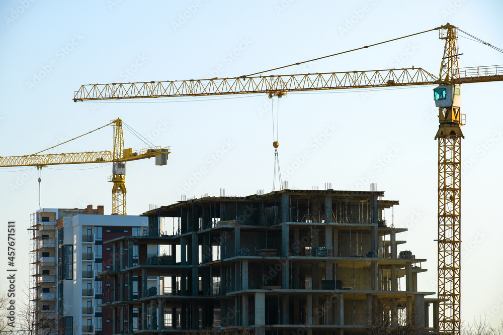 Aerial view of tower cranes and high residential apartment buildings under construction. Real estate development. Aerial view of tower cranes and high residential apartment buildings under construction. Real estate development.