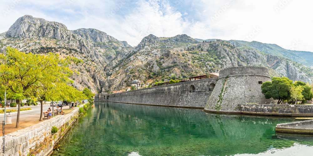 Kampana tower and medieval fortress walls with mountains and Scurda river green waters in the foreground, Kotor Bay, Montenegro