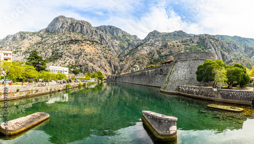 Kampana tower and medieval fortress walls with mountains and Scurda river green waters in the foreground, Kotor Bay, Montenegro