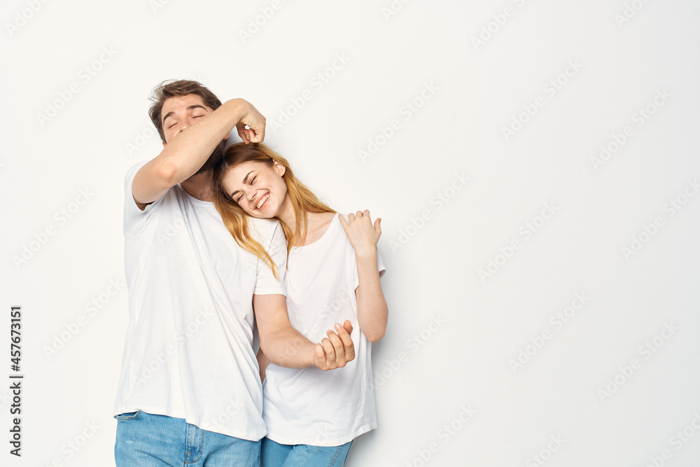 joyful man and woman in white t-shirts embrace friendship together joyful man and woman in white t-shirts embrace friendship together