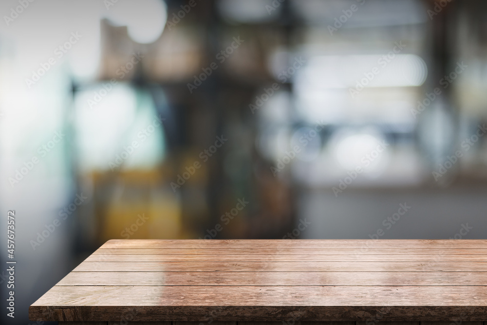 Empty wooden table top with lights bokeh on blur restaurant background.