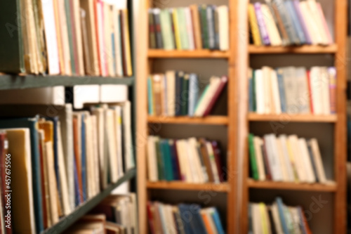 Blurred view of books on shelves in library