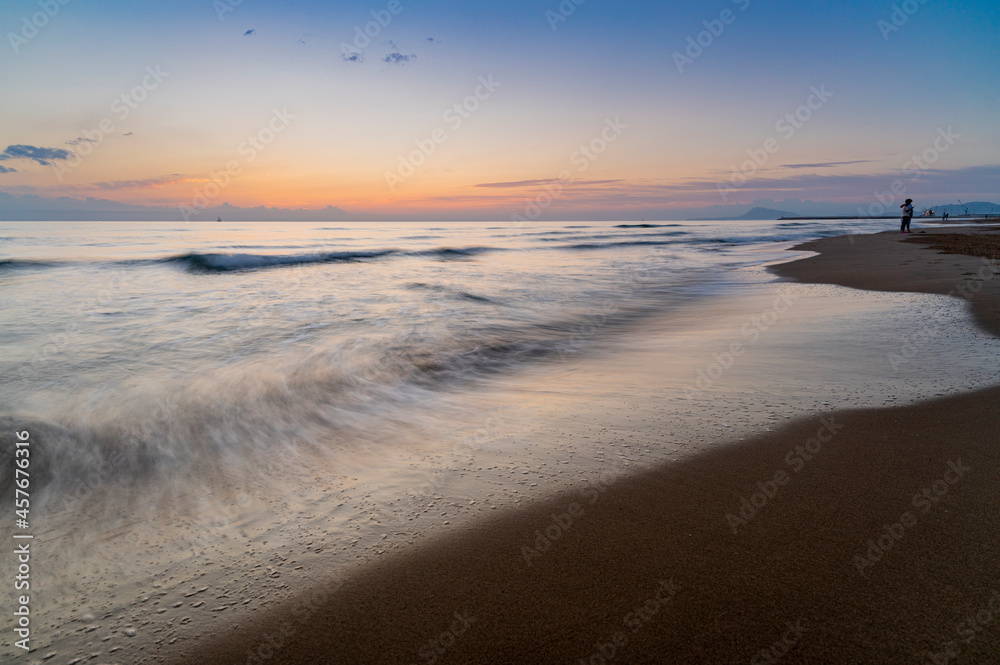 the sea and the beach at sunset