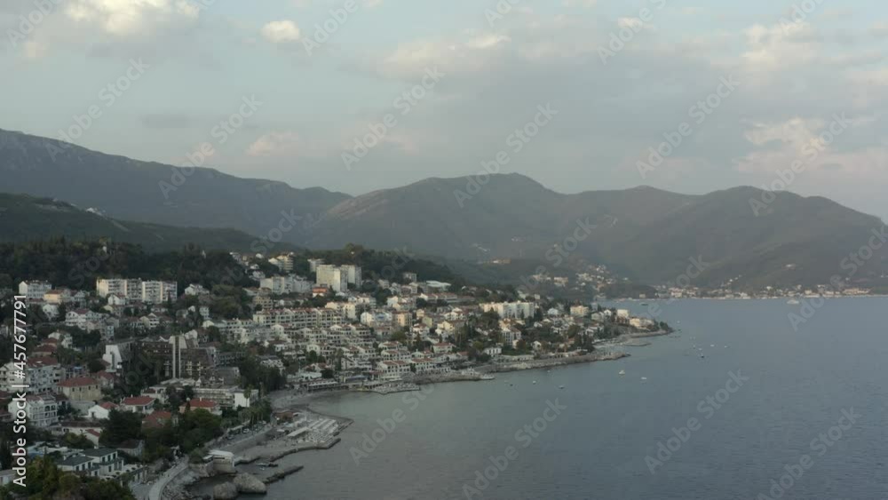 4K Town on the coast of the Mediterranean sea. Drone shot. The coastline of tourist holiday destinations. Aerial drone view of Herceg Novi on the sloping shore of Boka Kotor bay in Montenegro, Eu. 4K Town on the coast of the Mediterranean sea. Drone shot. The coastline of tourist holiday destinations. Aerial drone view of Herceg Novi on the sloping shore of Boka Kotor bay in Montenegro, Eu.