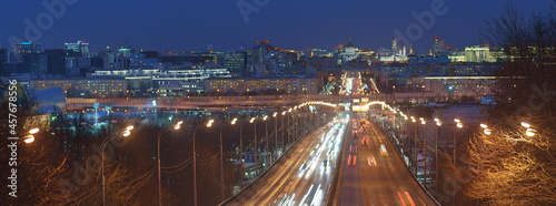 Long exposure of Moscow cityscape during night. Blurred lights of city. Big traffic. Road is filled out cars. Vernadsky avenue. Luzhnetsky bridge. Cathedral of Christ the Saviour, Kremlin Towers. photo