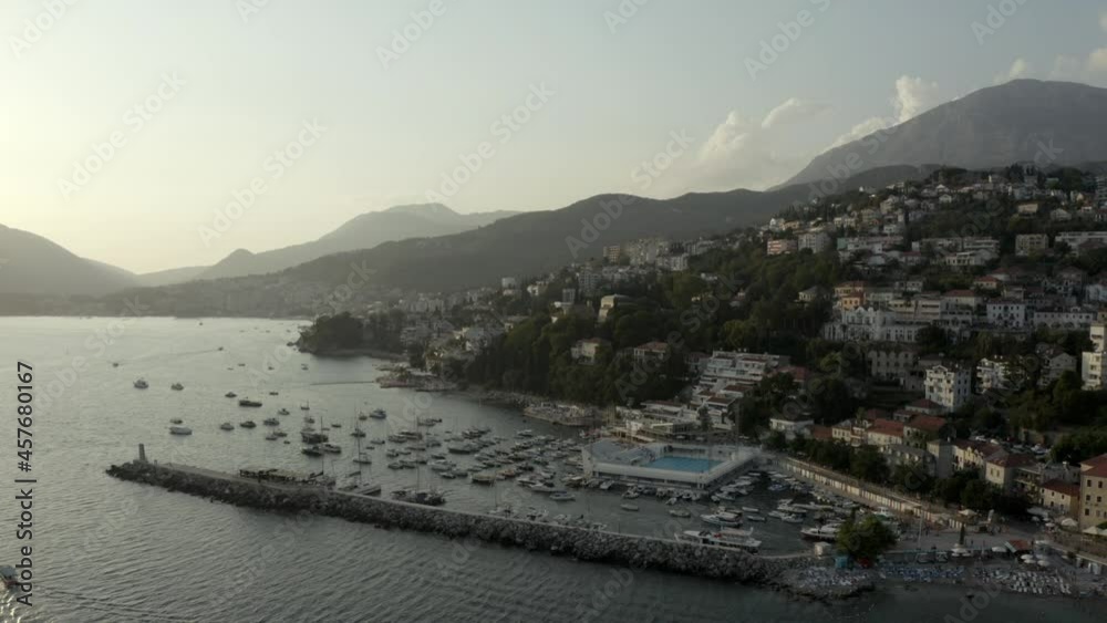 4K Town on the coast of the Mediterranean sea. Drone shot. The coastline of tourist holiday destinations. Aerial drone view of Herceg Novi on the sloping shore of Boka Kotor bay in Montenegro, Eu. 4K Town on the coast of the Mediterranean sea. Drone shot. The coastline of tourist holiday destinations. Aerial drone view of Herceg Novi on the sloping shore of Boka Kotor bay in Montenegro, Eu.