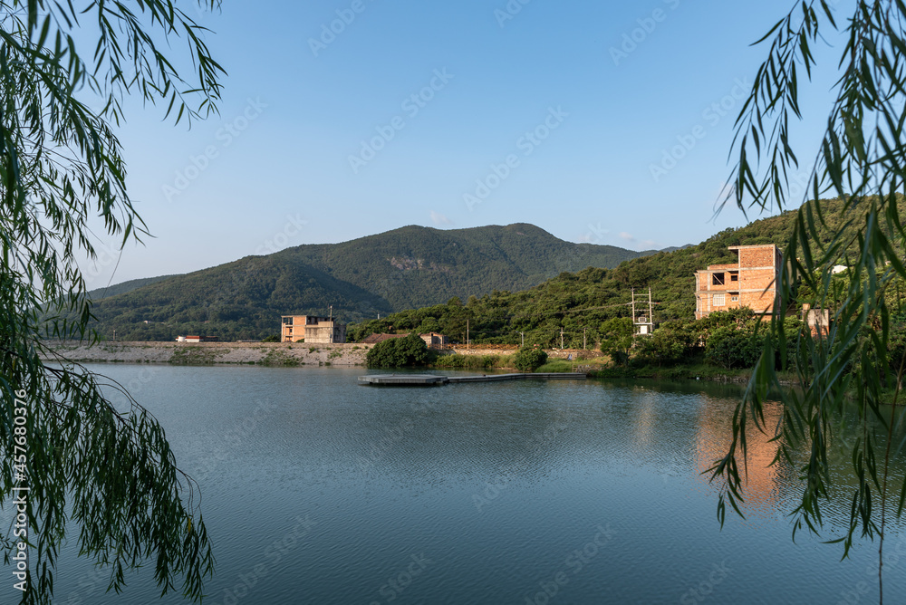 The lake reflects the mountains and villages