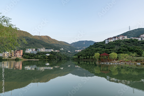 The lake reflects the mountains and villages