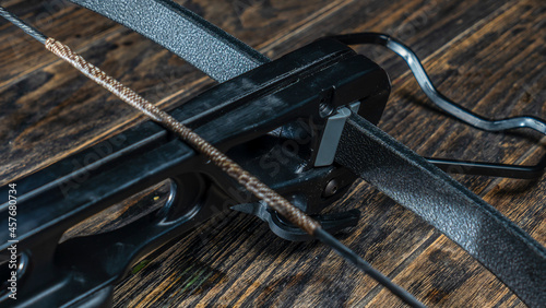 Canvas Print Part of modern compound crossbow handgun on the dark wooden background