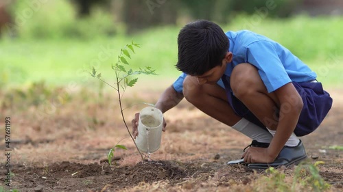 Indian school child doing tree plantation.
