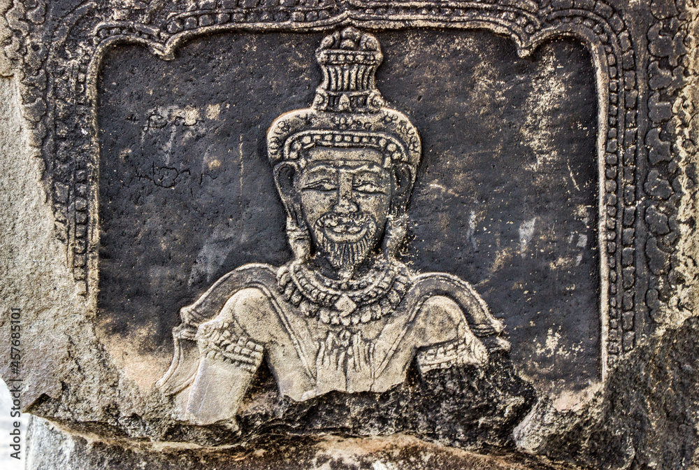detail stone carving on wall at Angkor Wat temple	in Cambodia 
