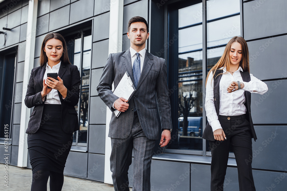 businessmen and women group happy to use smart phone to discuss and modern office building background. businessmen and women group happy to use smart phone to discuss and modern office building background.