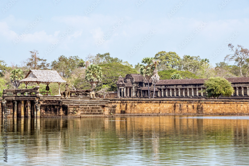 old ruins of Angkor Wat temple at lakeside in Cambodia	
