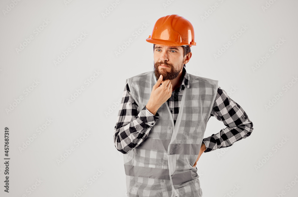 bearded man in orange hard hat construction professional light background bearded man in orange hard hat construction professional light background