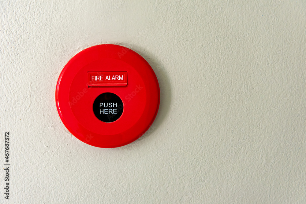 Fire alarm push button on the white concrete wall background in the building with copy space. Fire alarm push button on the white concrete wall background in the building with copy space.