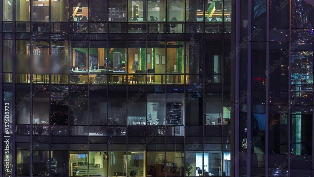 Big glowing windows in modern office buildings timelapse at night Big glowing windows in modern office buildings timelapse at night