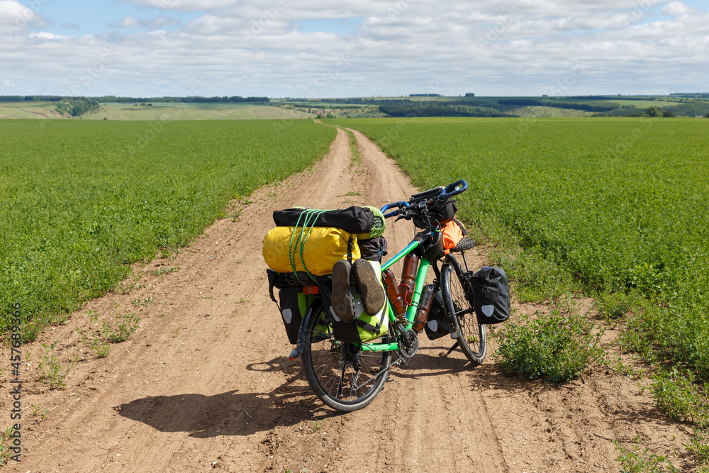 Traveler's bike standing on a field road. Cycling travel. Traveler's bike standing on a field road. Cycling travel.