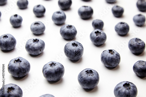 Blueberries with shadows on white table