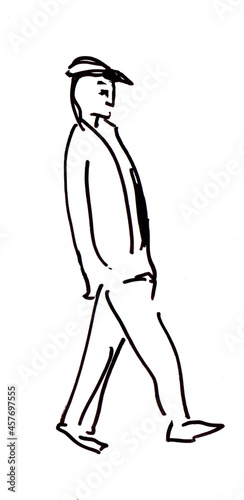 man walking along street photo