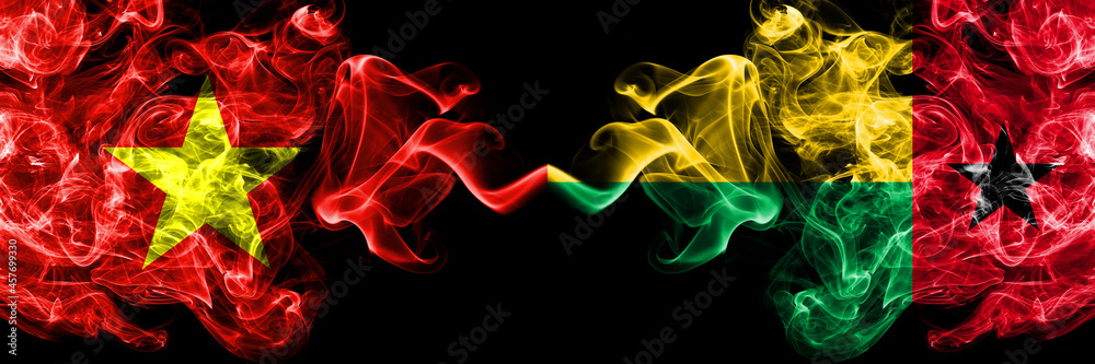 Vietnam, Vietnamese vs Guinea Bissau smoke flags side by side. Vietnam, Vietnamese vs Guinea Bissau smoke flags side by side.