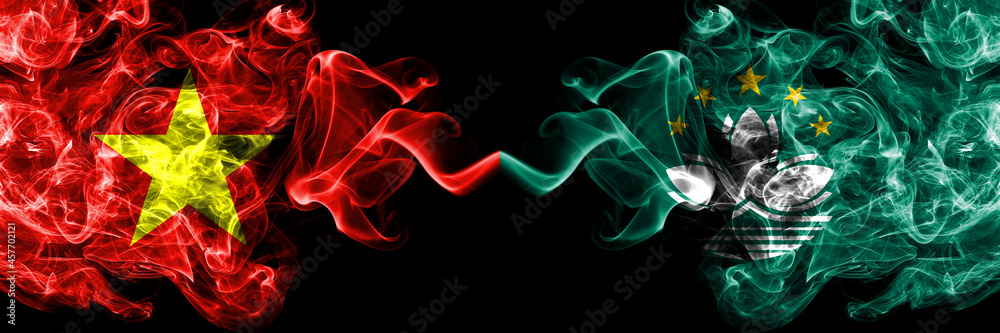 Vietnam, Vietnamese vs Macau, China, Chinese smoke flags side by side. Vietnam, Vietnamese vs Macau, China, Chinese smoke flags side by side.