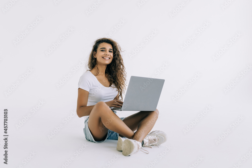 Happy smiling woman working on laptop isolated on white background Happy smiling woman working on laptop isolated on white background