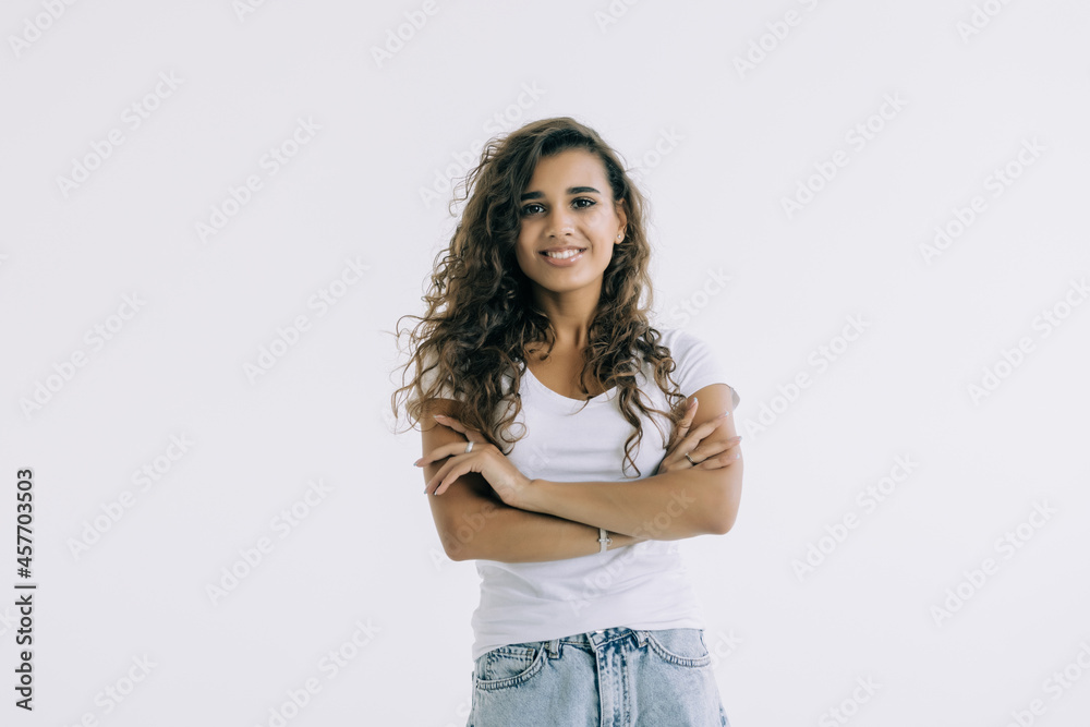 Portrait of a happy woman standing with arms folded on a white background Portrait of a happy woman standing with arms folded on a white background