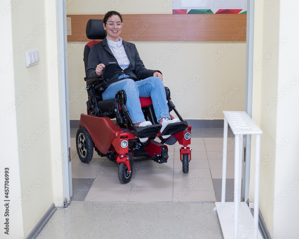 Caucasian woman in electric wheelchair in university corridor. Caucasian woman in electric wheelchair in university corridor.