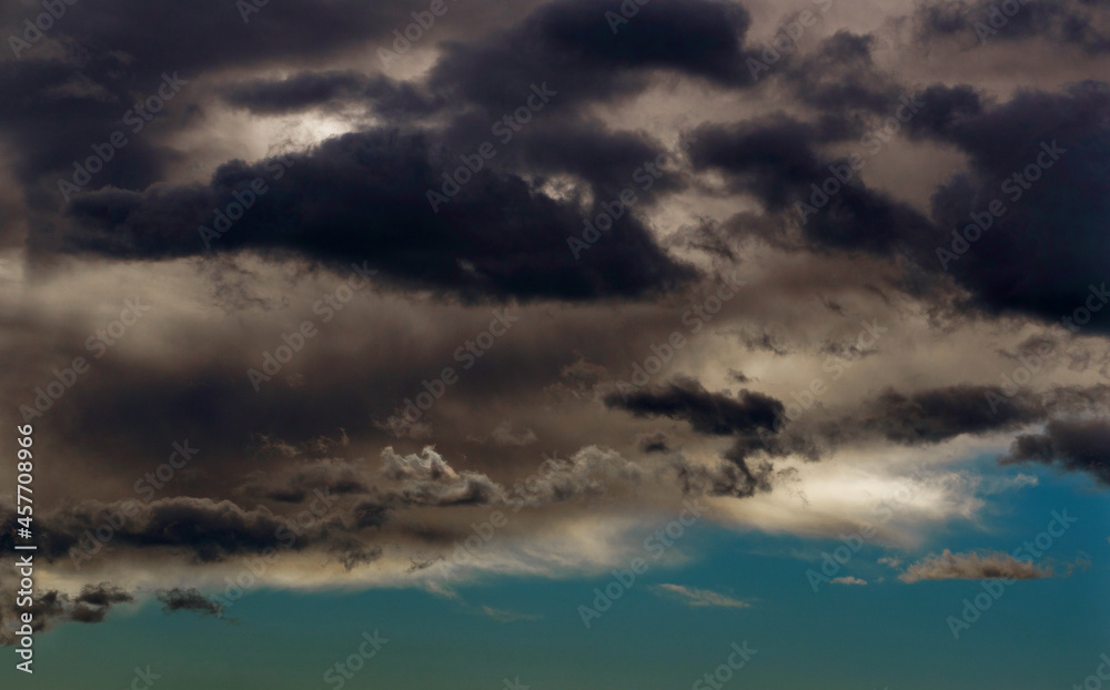 Light in the Dark and Dramatic Storm Clouds. Background of storm clouds before a thunder-storm Light in the Dark and Dramatic Storm Clouds. Background of storm clouds before a thunder-storm