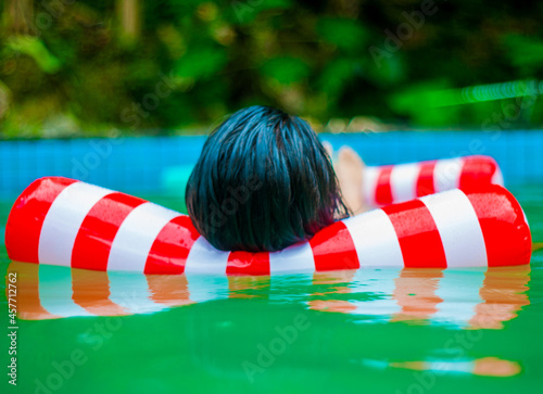 woman in water on white and red floater