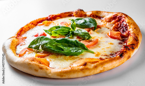 Pizza with Mozzarella cheese, Tomatoes, pepper, Spices. Italian pizza. Pizza Margherita or Margarita on grey background
