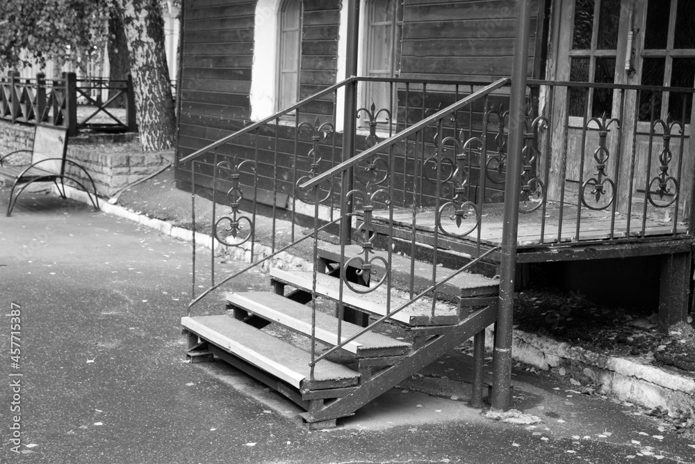 Fototapeta premium Stairs to a wooden house, black and white image