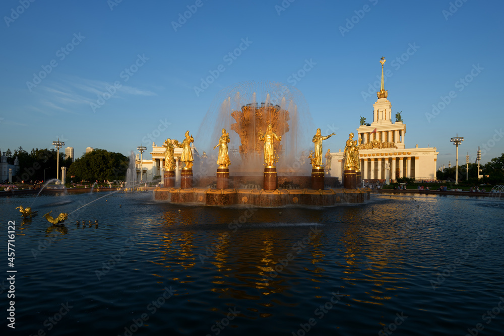 Fountain of friendship of the people evening view at VDNH exhibition with clear blue sky and clouds in Moscow, tourism in Russia capital. Architecture of Soviet Union era, travel to Russia capital.