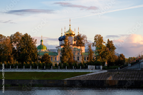 Beautiful city Tver landscape view of imperial palace at sunset on river Volga embankment with garden trees, dramatic sunset sky and russian buildings. Small city architecture concept. Tver, Russia.
