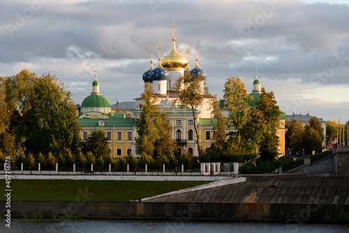 Beautiful city Tver landscape view of imperial palace on river Volga embankment with garden trees, dramatic autumn evening sky and russian buildings. Small city architecture concept. Tver, Russia.