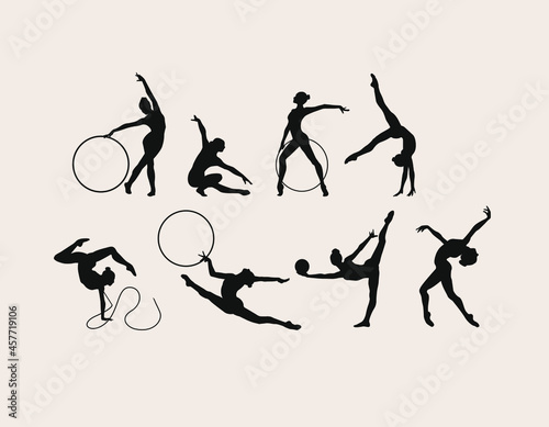 A set of seven vector black silhouettes of gymnasts athletes photo