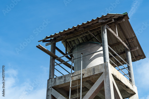 Water tank house, white clouds and blue sky