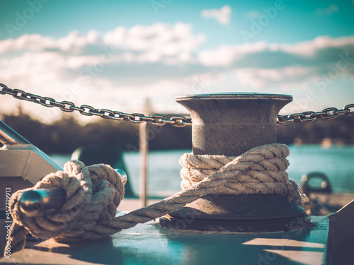 Fotografi Rope knotted around steel pole for securing the boat