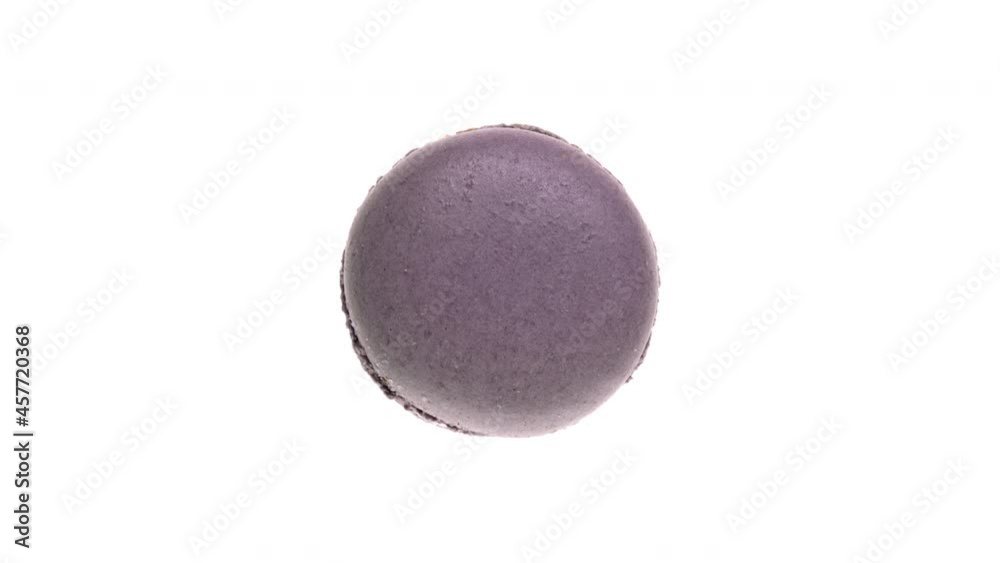 Top view of violet macaroon cookie rotating. Isolated on white background. Top view of violet macaroon cookie rotating. Isolated on white background.